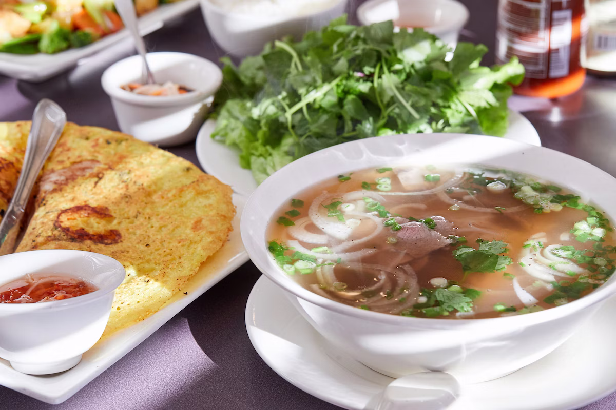 Lang Van Vietnamese Restaurant signature dishes Pho (various styles), Banh Xeo (crispy crepe), Com Chien (fried rice dishes), Goi Cuon (fresh spring rolls), Ca Chien (crispy whole fish).